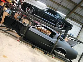 mufp_0707_01_z+dynacorn_1967_ford_mustang_fasback_body+on_the_lift.webp