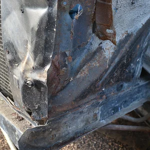 Accident damage to the left front fender apron